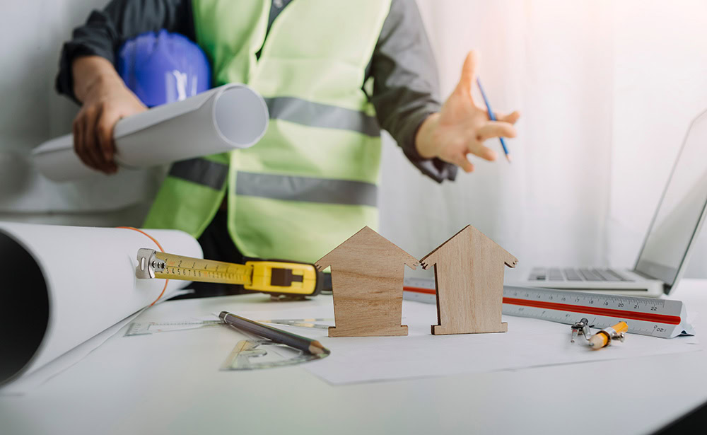 A builder looking at building plans for property development.